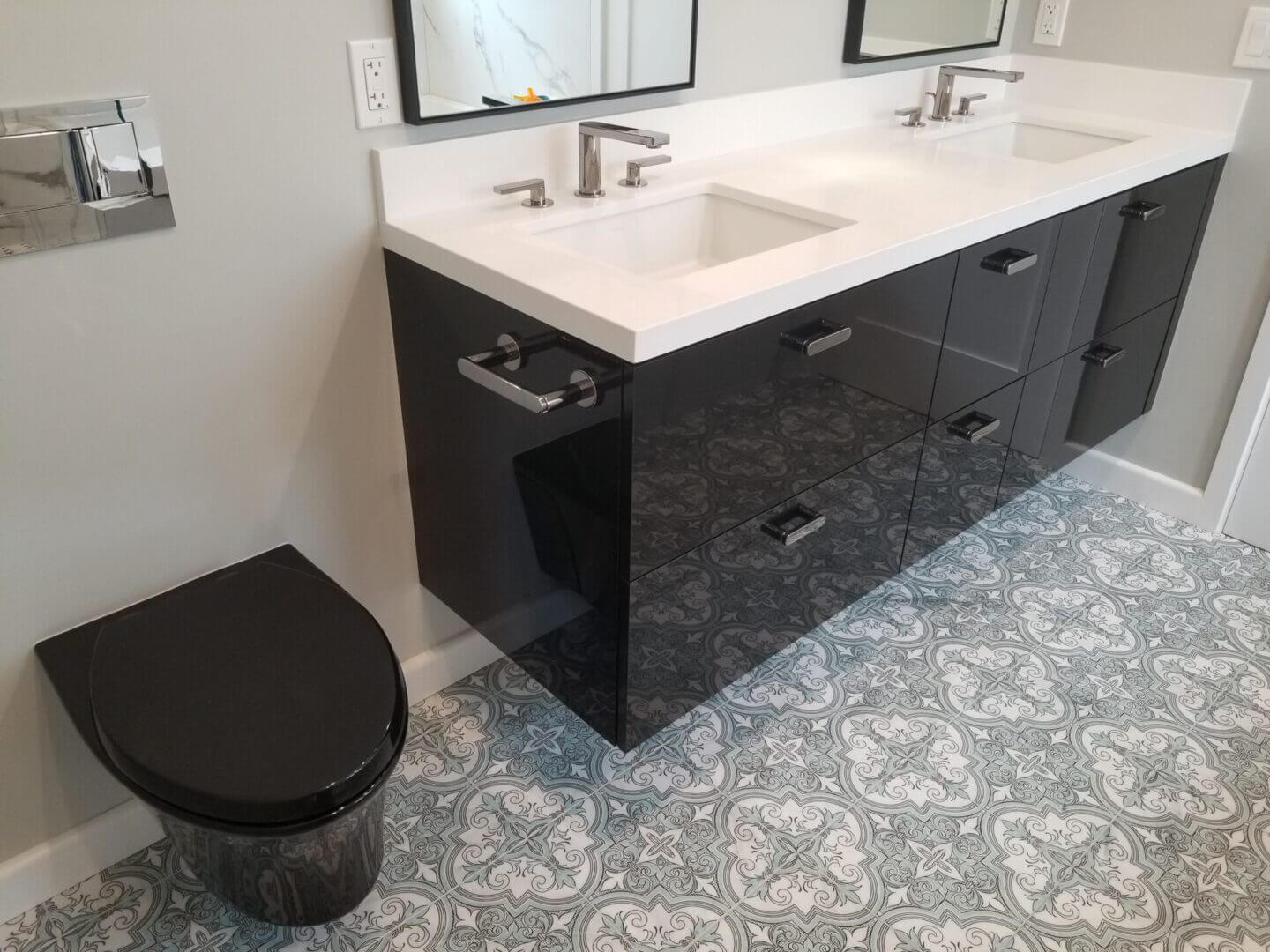 Glossy black floating vanity with patterned floor
